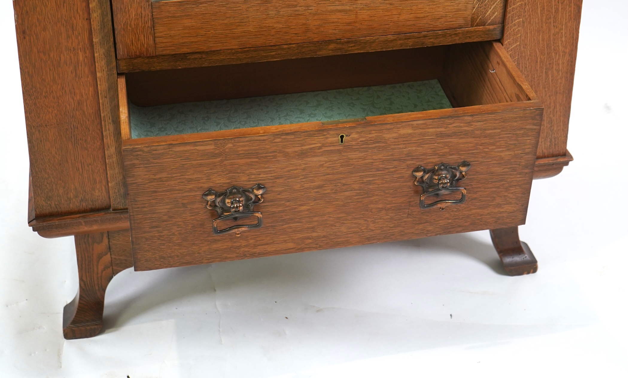 Manner of Liberty & Co: An Arts and Crafts Egyptian revival copper mounted oak wardrobe